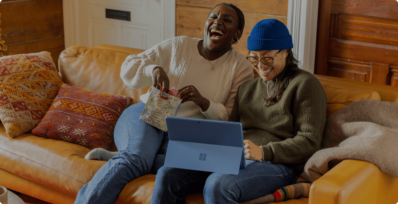 Two people looking at a laptop together